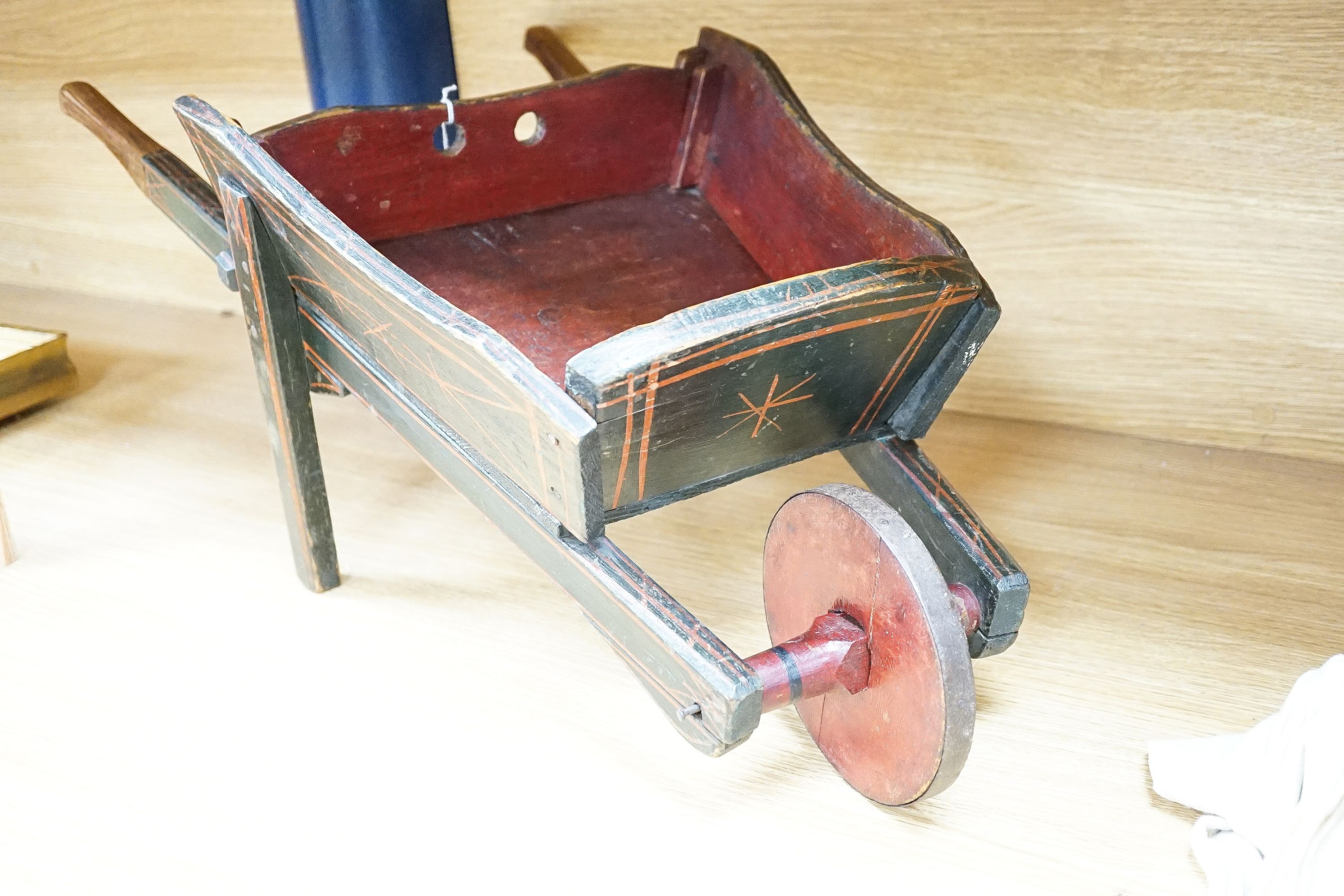 Miniature painted wood wheel barrel, 74cm long